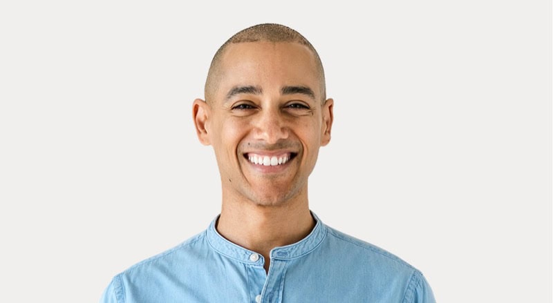 Smiling man with a bright smile, wearing a light blue shirt, for Stable Card News.